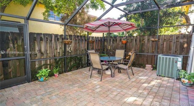 view of patio / terrace with glass enclosure and central AC