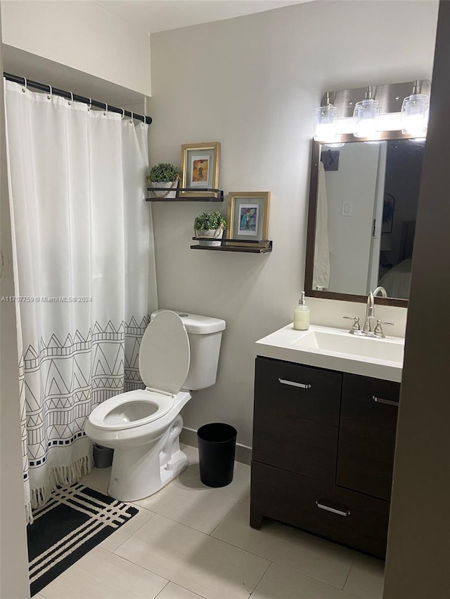 bathroom featuring toilet, vanity, and tile patterned floors