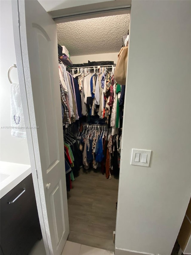 walk in closet featuring light hardwood / wood-style flooring