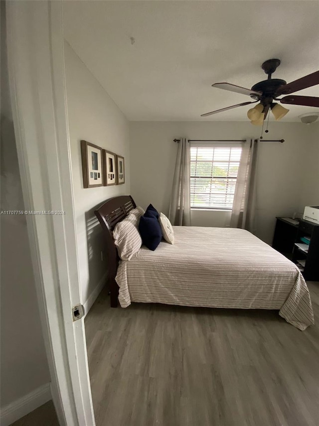 bedroom with hardwood / wood-style flooring and ceiling fan