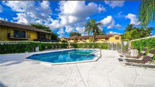 view of swimming pool with a patio