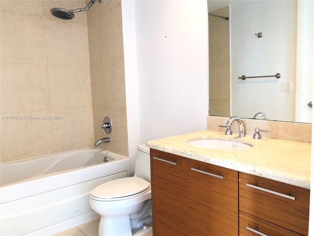 full bathroom featuring tile patterned floors, tiled shower / bath combo, toilet, and vanity