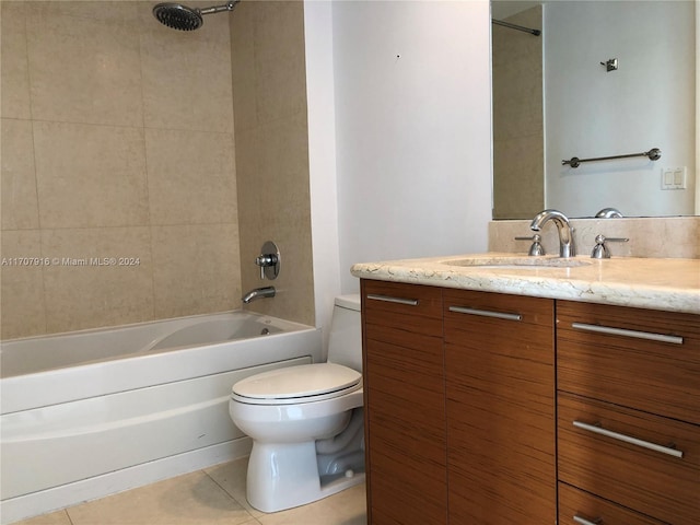 full bathroom featuring tile patterned flooring, vanity, toilet, and tiled shower / bath