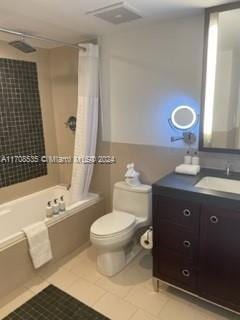 full bathroom with toilet, vanity, tile patterned floors, and shower / bath combo with shower curtain