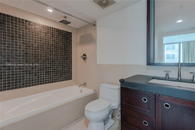 full bathroom featuring tile patterned flooring, vanity, tiled shower / bath combo, and toilet