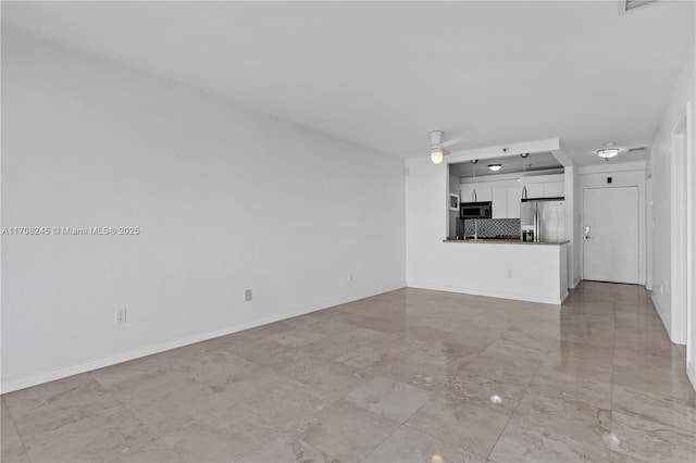 unfurnished living room featuring ceiling fan