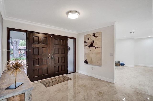 foyer featuring ornamental molding