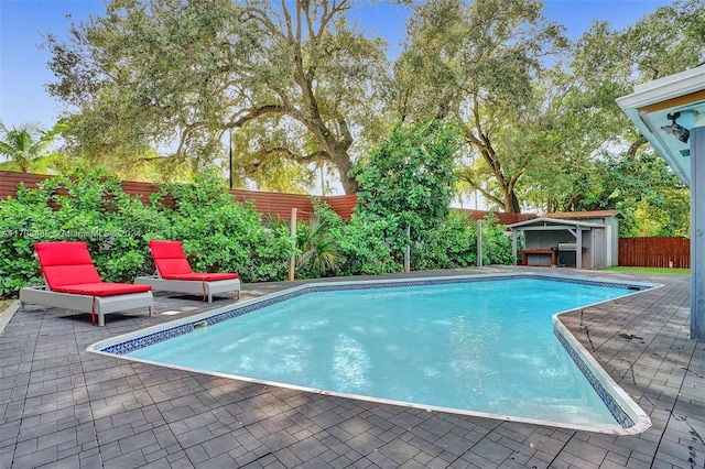 view of pool featuring a patio area and an outdoor structure