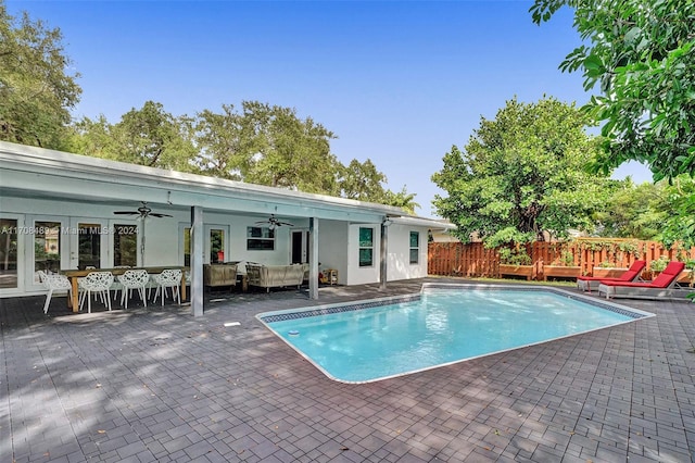 view of pool featuring french doors, an outdoor hangout area, ceiling fan, a wooden deck, and a patio