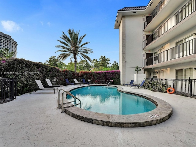 view of swimming pool featuring a patio area