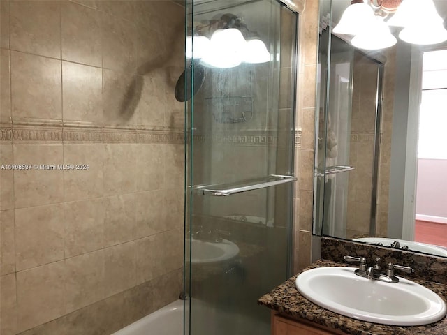 bathroom with shower / bath combination with glass door and vanity