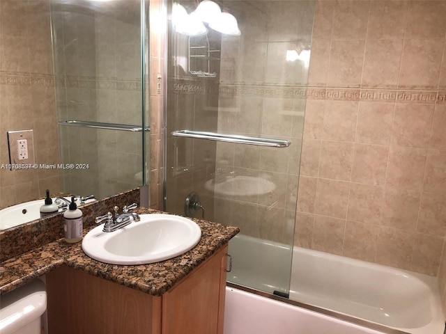 bathroom with vanity and enclosed tub / shower combo