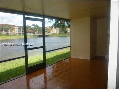 unfurnished sunroom with a water view