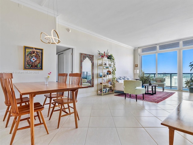 dining space with an inviting chandelier, light tile patterned flooring, crown molding, and floor to ceiling windows