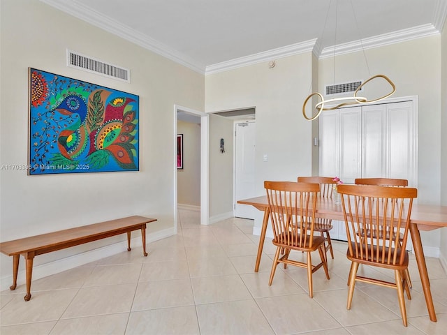 dining room with light tile patterned floors and crown molding