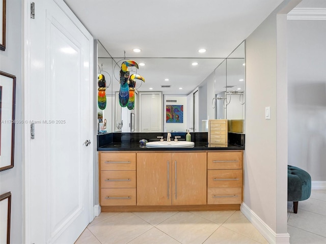 bathroom with crown molding, tile patterned floors, and vanity