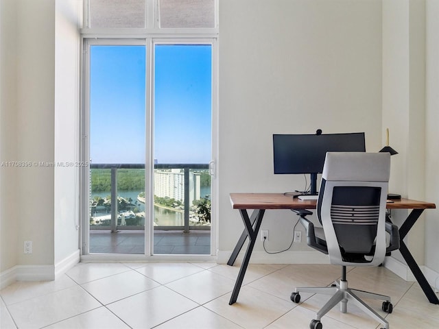 office with light tile patterned floors and plenty of natural light