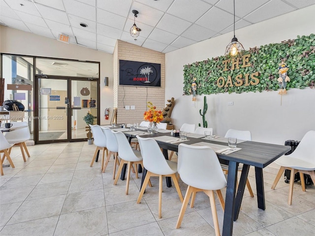 dining area with a paneled ceiling