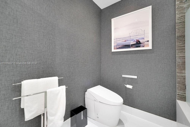 bathroom featuring toilet and tile walls