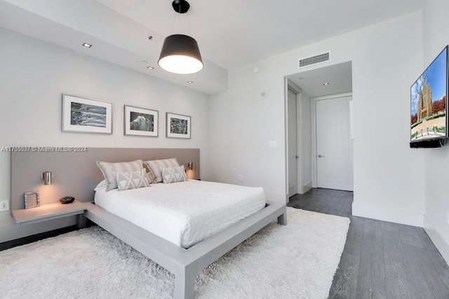 bedroom with dark wood-type flooring