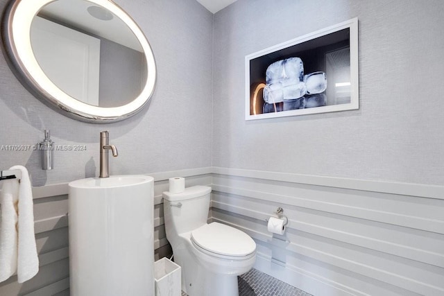 bathroom with tile patterned flooring and toilet