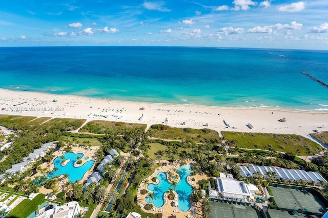 aerial view with a water view and a beach view