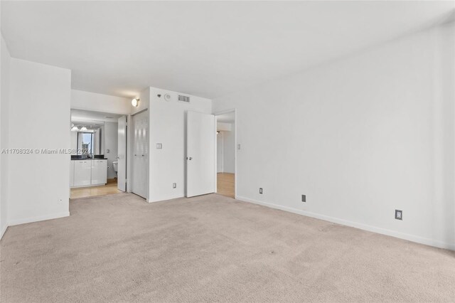 spare room with light colored carpet