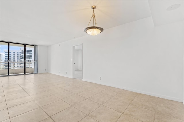 tiled spare room with floor to ceiling windows