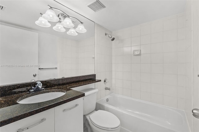 full bathroom featuring vanity, toilet, and tiled shower / bath