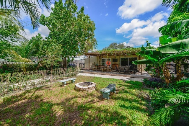 view of yard with a patio and an outdoor fire pit