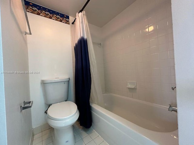 bathroom with tile patterned flooring, shower / tub combo, and toilet