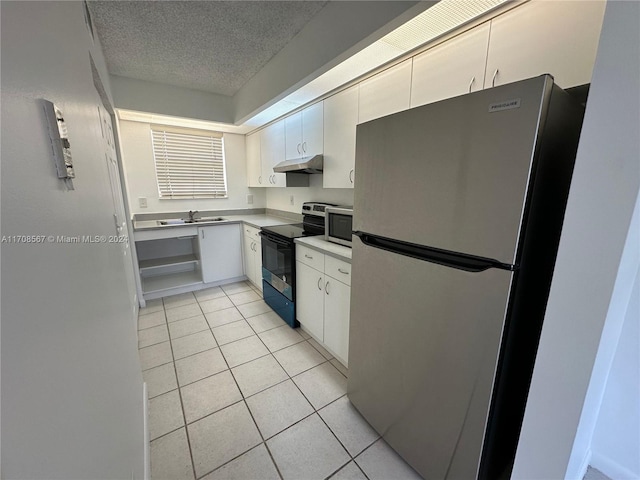 kitchen featuring sink, stainless steel appliances, white cabinets, a textured ceiling, and light tile patterned flooring