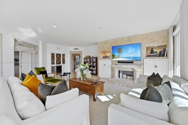 living room featuring a stone fireplace