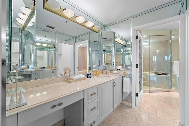 bathroom with tile patterned floors, a shower with door, and vanity