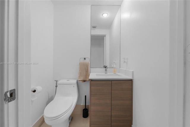 bathroom with tile patterned floors, vanity, and toilet