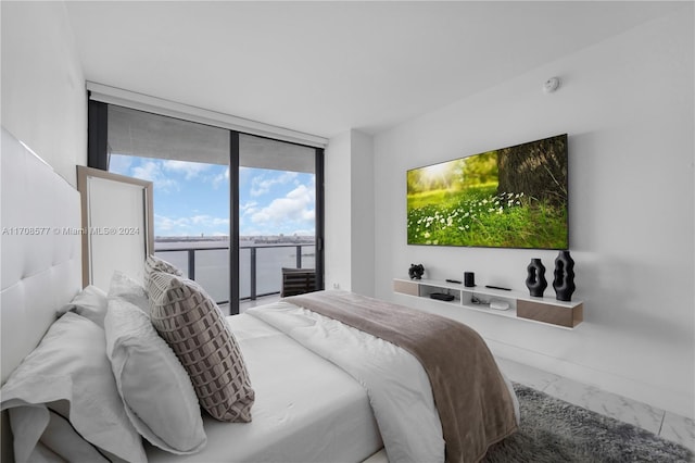 bedroom with expansive windows and access to outside