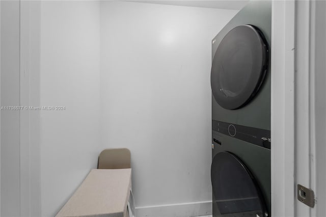 laundry room with stacked washer / dryer