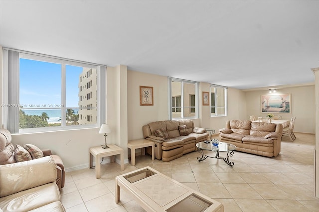 living room featuring light tile patterned floors and ornamental molding