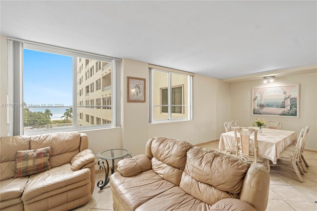 5005 Collins Ave Unit 425, Miami Beach, FL 33140 - living area with light tile patterned floors and a water view