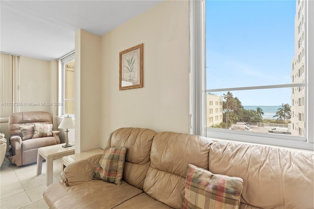 living room with a water view and light tile patterned floors