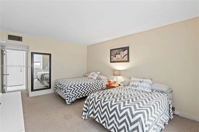 bedroom with light colored carpet