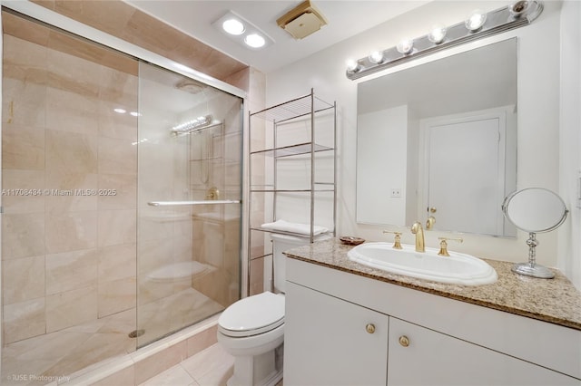 full bath with toilet, a stall shower, tile patterned flooring, and vanity