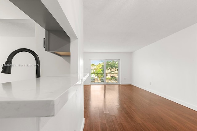 unfurnished living room featuring hardwood / wood-style floors