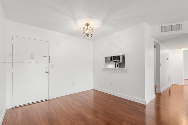 interior space featuring hardwood / wood-style floors and a textured ceiling