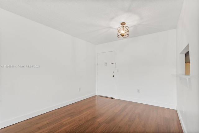 empty room featuring hardwood / wood-style floors and a textured ceiling