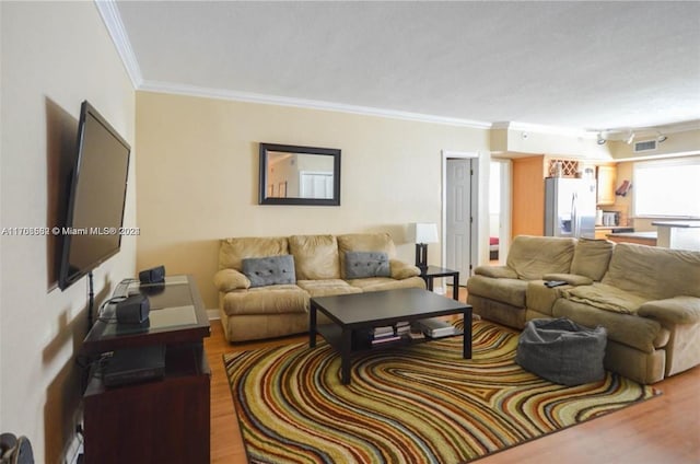 living room featuring crown molding and wood-type flooring