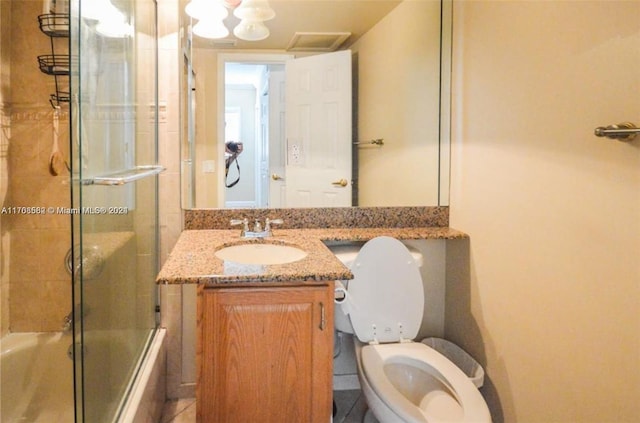 full bathroom featuring shower / bath combination with glass door, vanity, and toilet