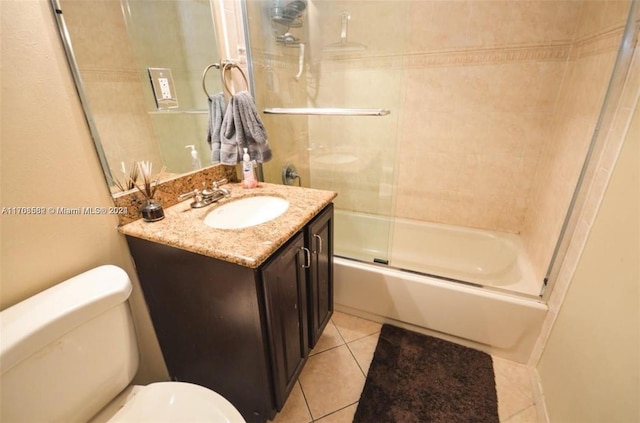 full bathroom with tile patterned flooring, vanity, toilet, and enclosed tub / shower combo