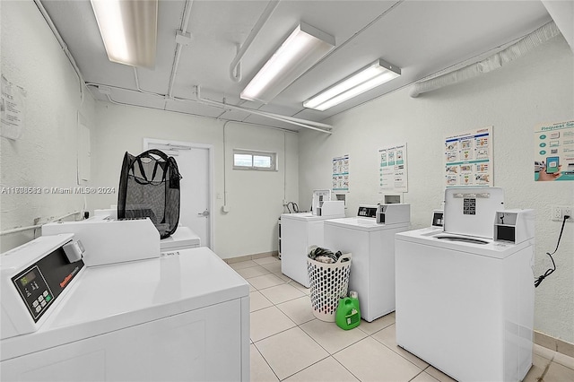 laundry room with light tile patterned flooring and independent washer and dryer