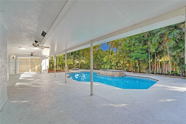 view of swimming pool featuring ceiling fan, a patio area, and an in ground hot tub